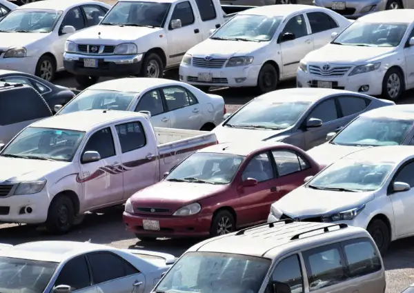 A row of cars in an airport parking area