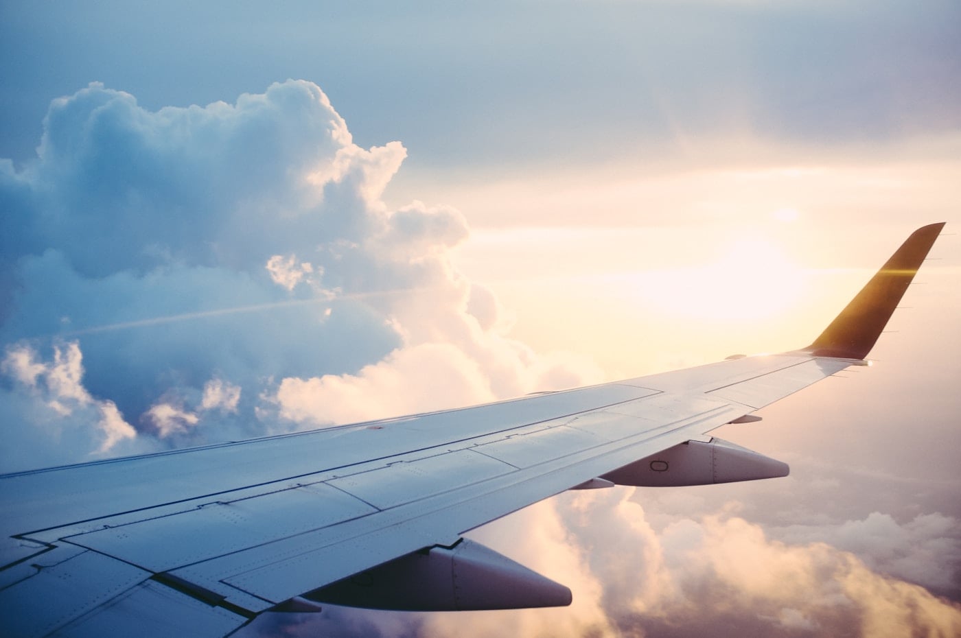 Airplane wing above clouds