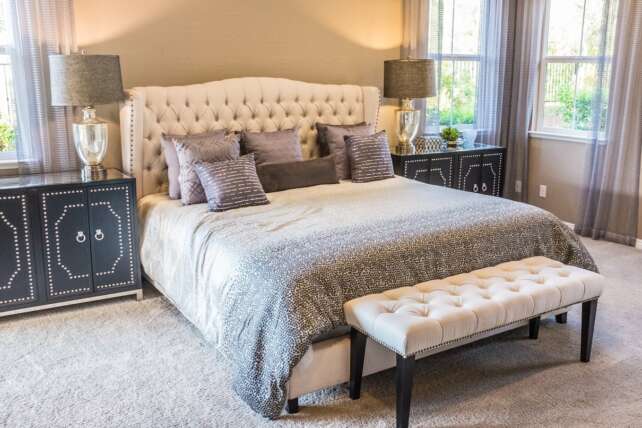 Bright bedroom with a made bed and bedside tables