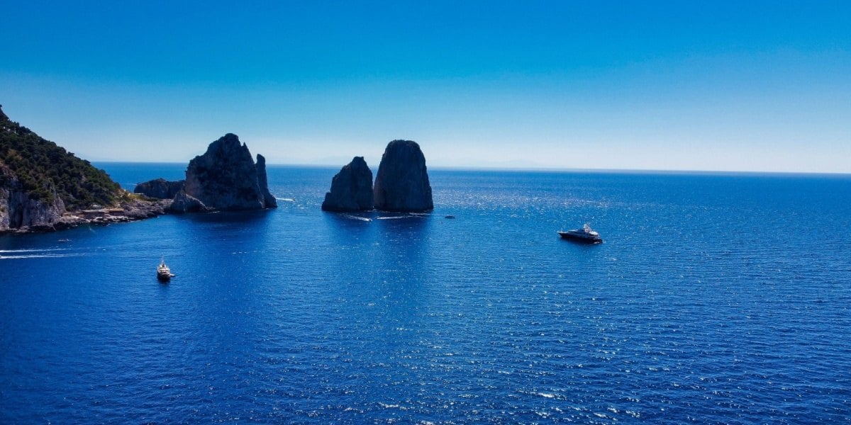 Boats near the Faraglioni rocks and Marina Piccola in Capri