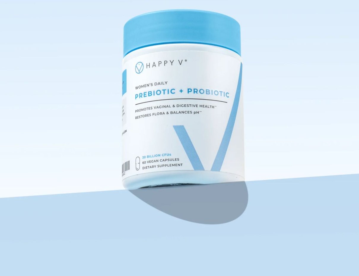 Happy V Prebiotic + Probiotic bottle on a blue background