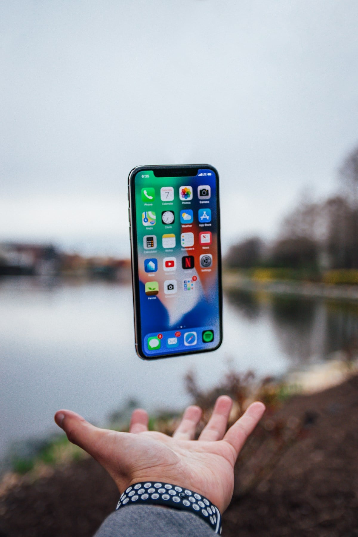 Smartphone floating above a hand