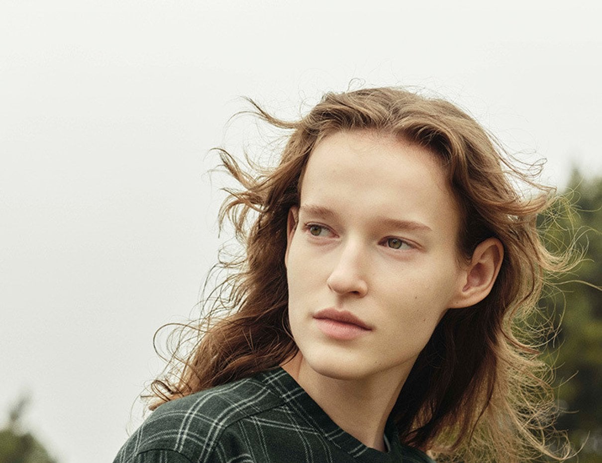 Person wearing understated MUJI clothing in an autumn setting