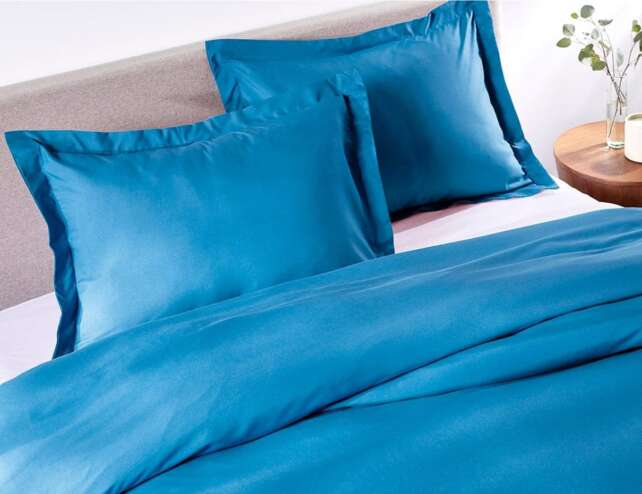 Bahama Blue duvet cover styled on a bedroom bed