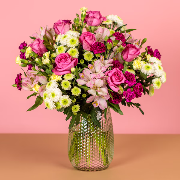 Loving Embrace bouquet with pink roses and yellow and purple carnations