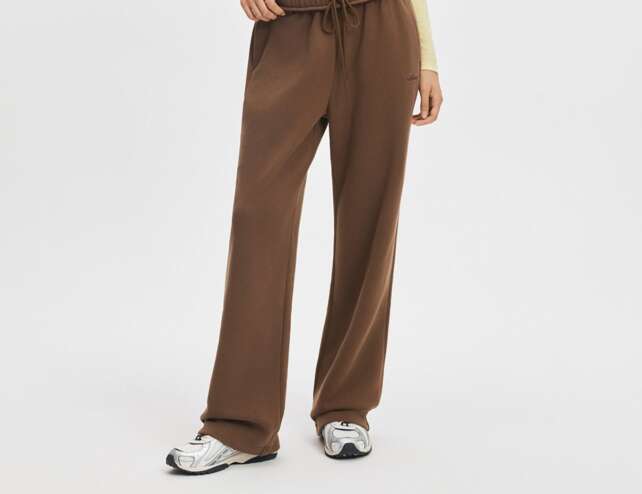Model wearing mocha wide leg sweatpants from ShopAthluna Affiliate