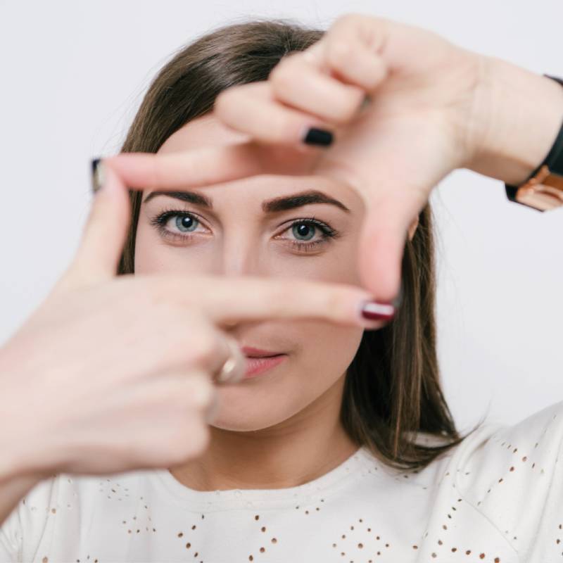 Woman framing her face with her hands