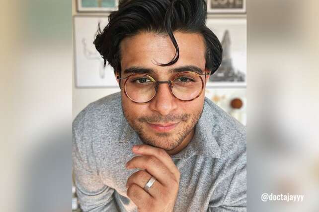 A person wearing Fytoo Global Rory round tortoiseshell glasses indoors