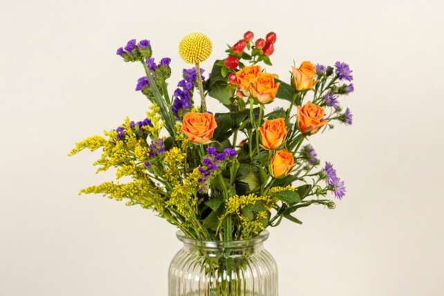 Bright Posy bouquet with orange roses and colourful seasonal flowers